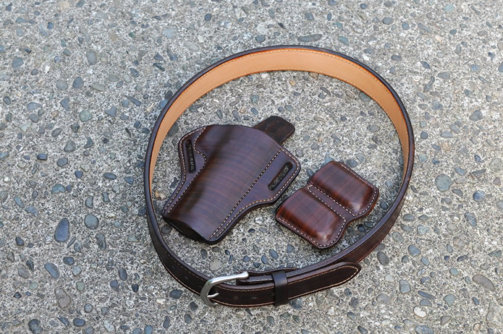 Photo of a holster, magazine pouches and belt set for a 1911 pistol in chocolate brown leather.