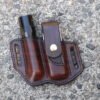 Front view of a belt holster for Leatherman Surge multitool and Surefire flashlight shown in hand dyed chocolate brown leather and configured for left side wearing.