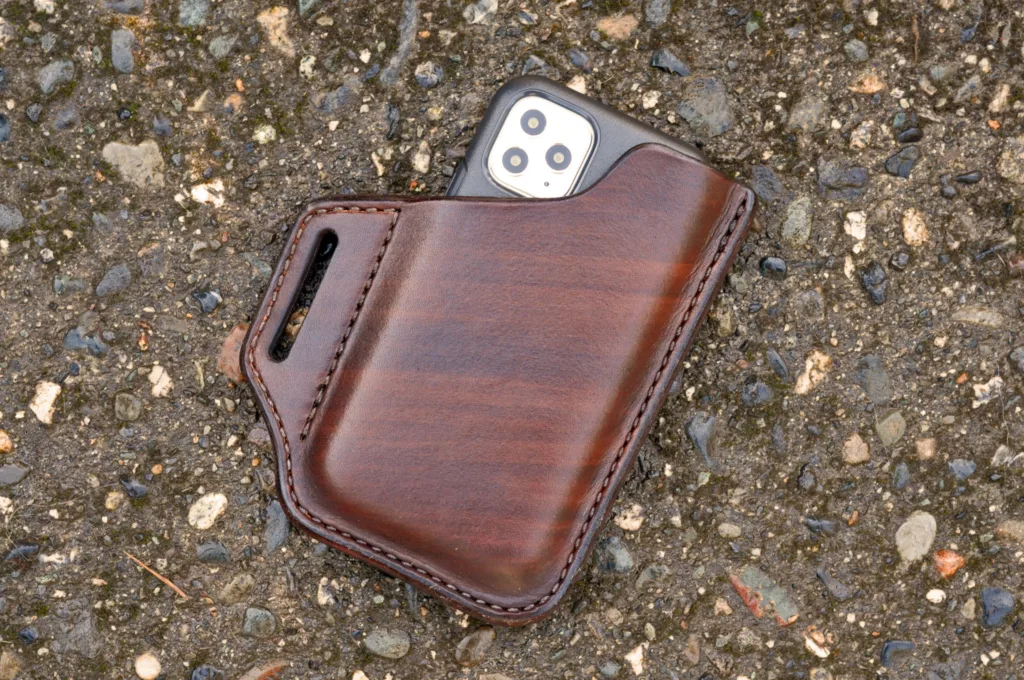 Front view of an iPhone belt holster hand made from chocolate brown leather.