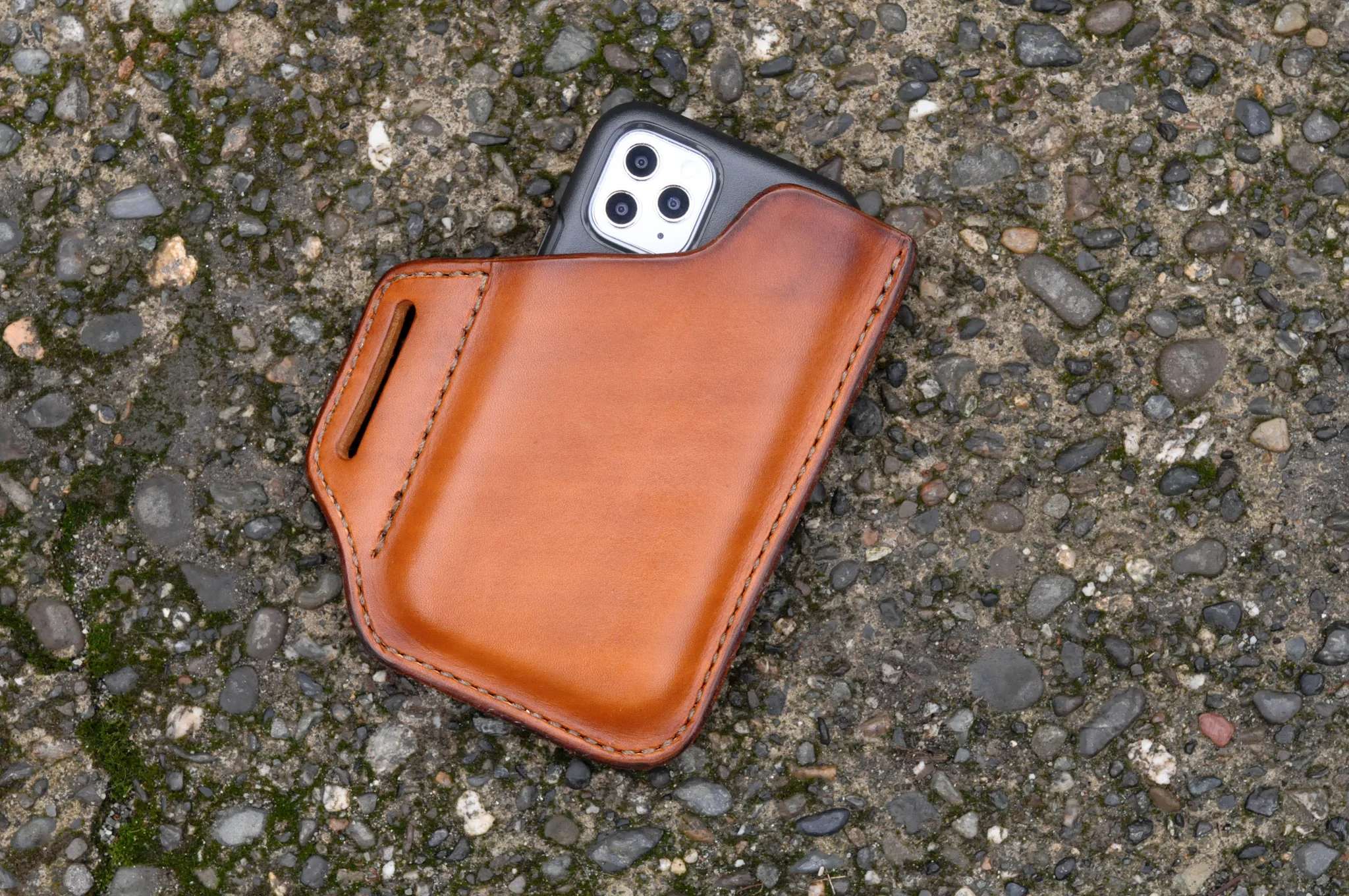 Front view of an iPhone holster made from hand dyed cognac leather
