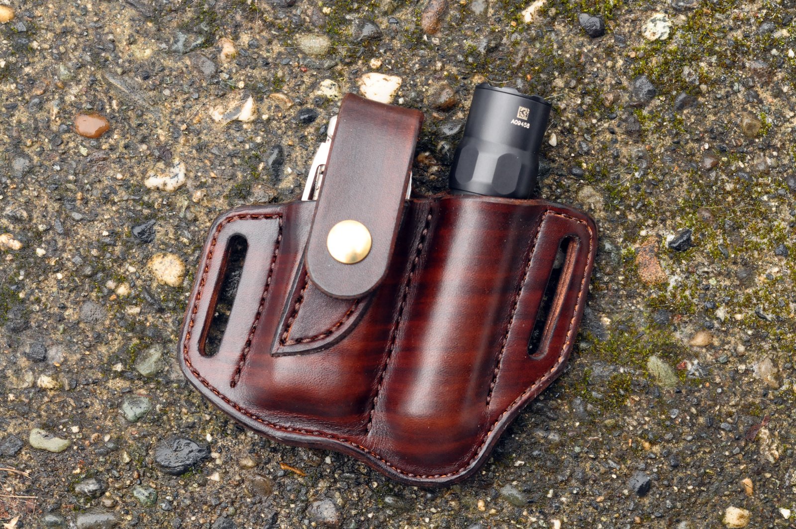 Front view of a holster for Leatherman Wave and flashlight in hand dyed chocolate brown leather.