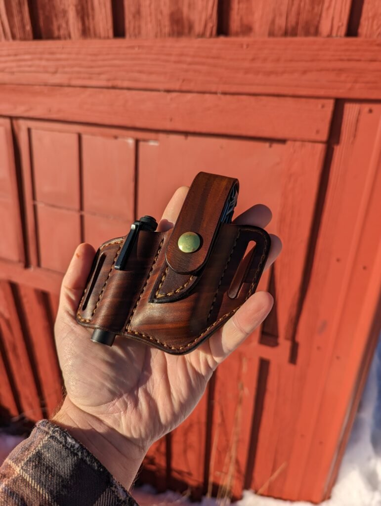 Front view of brown leather sheath for Leatherman multitool and Streamlight Microstream flashlight