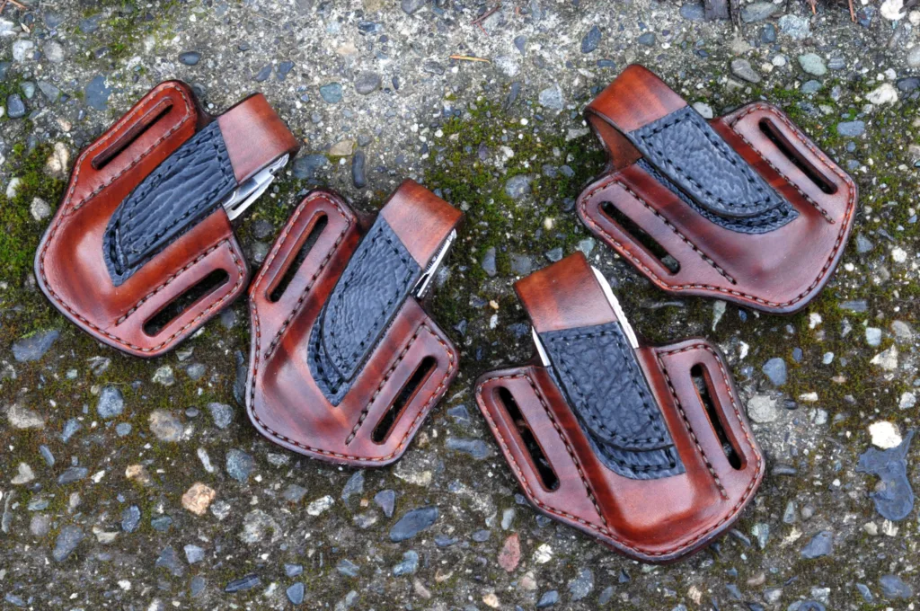 Front view of four Leatherman sheaths made from hand dyed brown leather with black sharkskin trim pieces
