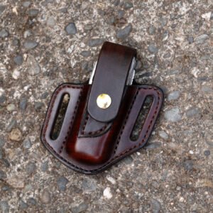 Front view of a Leatherman Surge multitool sheath shown in chocolate brown leather with a brass snap