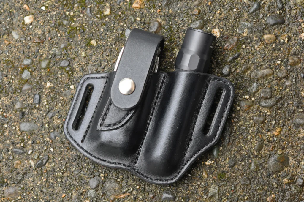 Front view of a sheath for a Leatherman Wave and flashlight shown in black leather