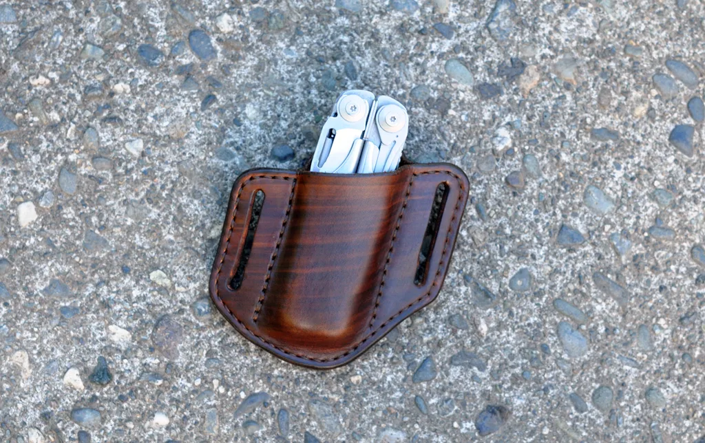 Front view of an open top belt sheath for a Leatherman Surge multitool shown in hand dyed brown leather.