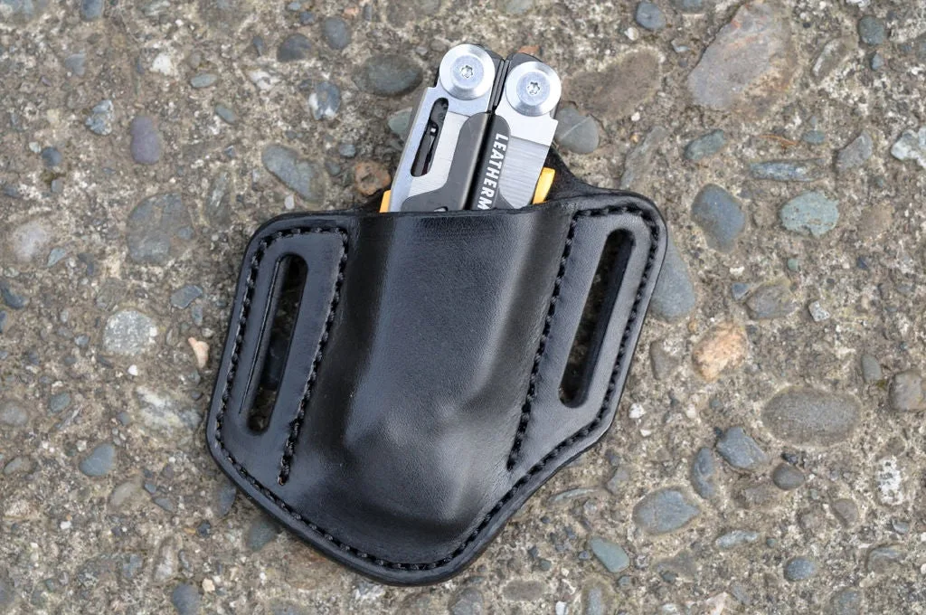 Front view of a black leather open top Leatherman Signal sheath sitting on a cement surface